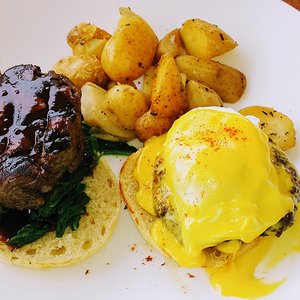 Steak and eggs benedict with potatoes